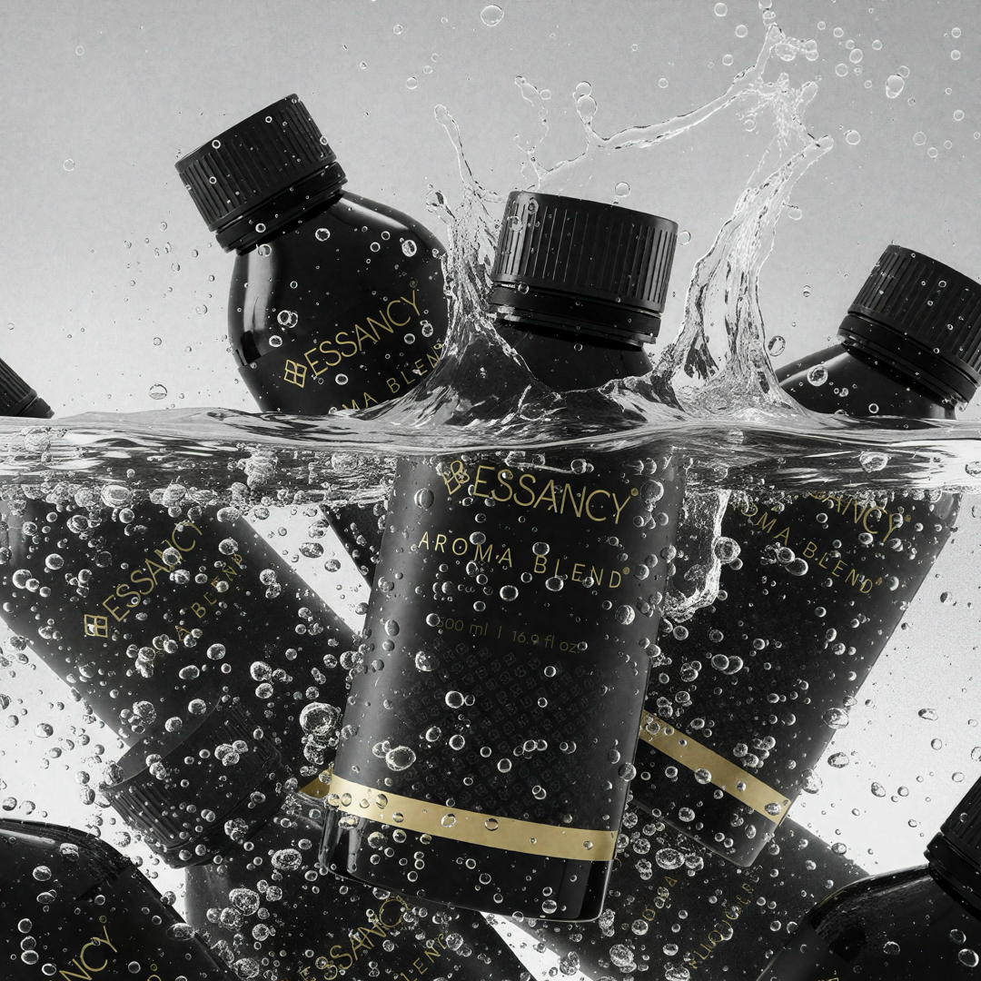 Essancy perfume bottles with water splashes on a gray background